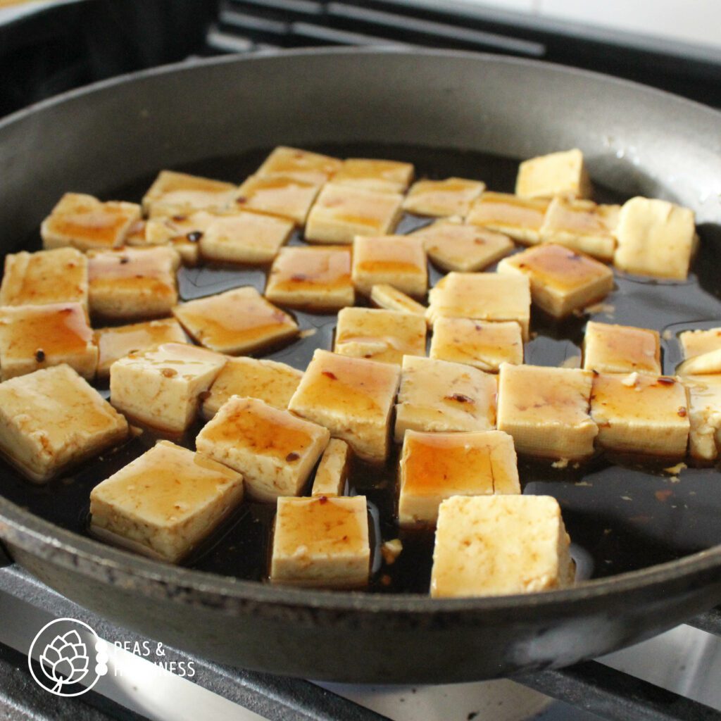 How to Cook Tofu: Tofu cubes cooking in teriyaki sauce