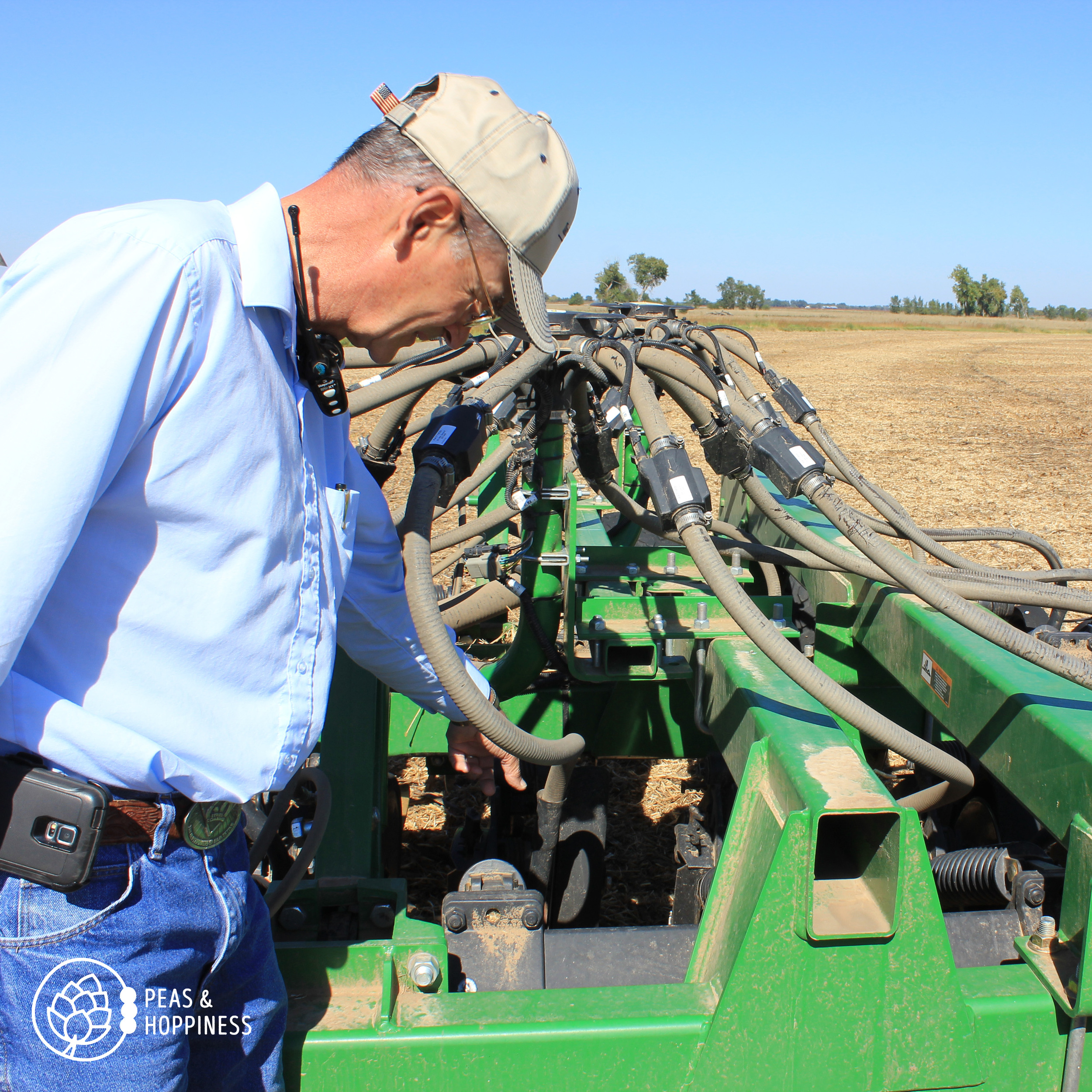 Dad (Lee) explains how the air seeder works - using air pressure to push a wheat kernel underground, followed by a heavy disc that cuts through last season's residue to place dry fertilizer under the ground next to the seed