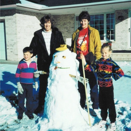 Building a snowman with brother Ray, Mom, and Aunt Sue