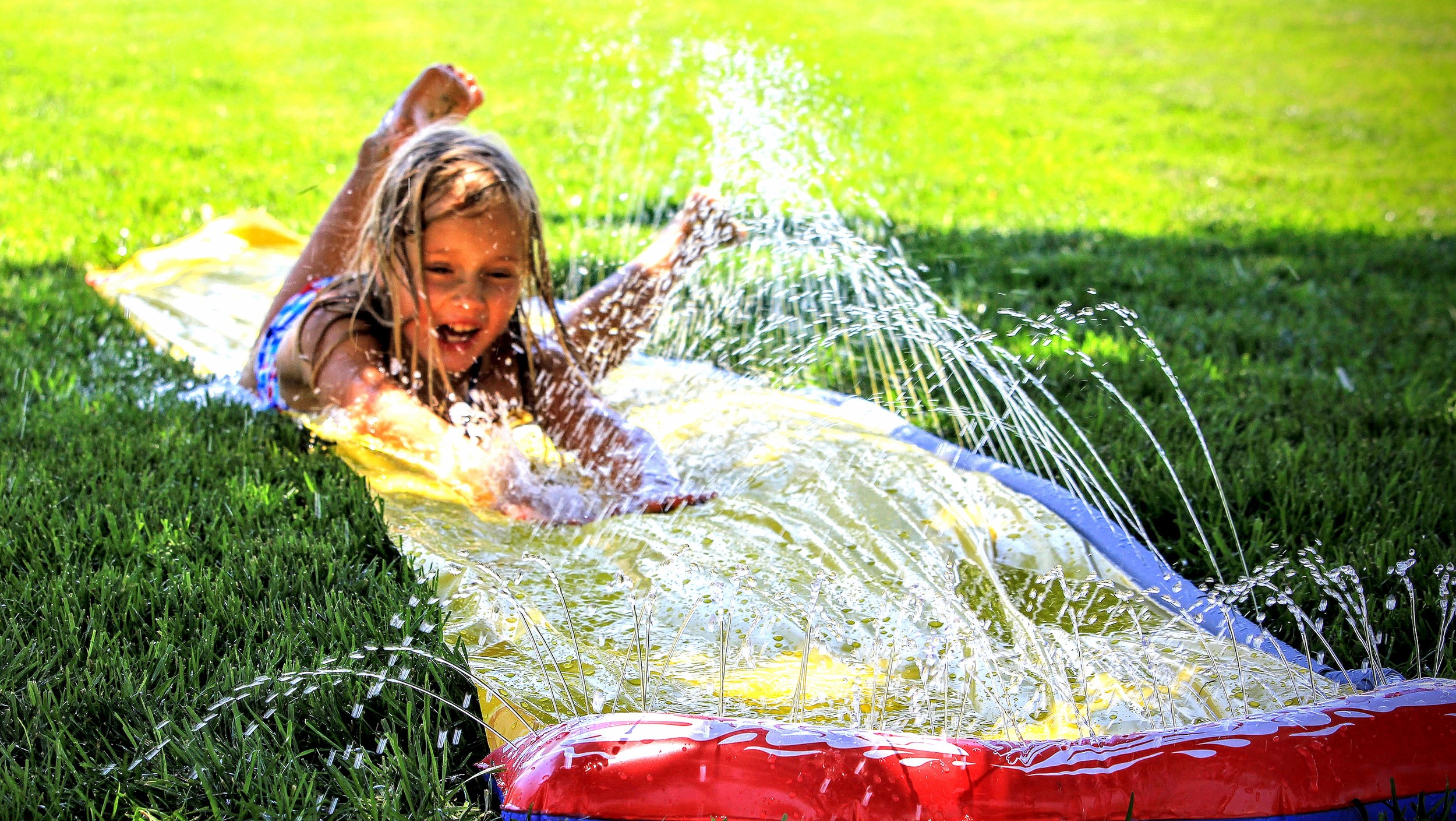 My super-awesome, fun, creative, talented niece enjoying a little summer slip-n-slide. She's going places.