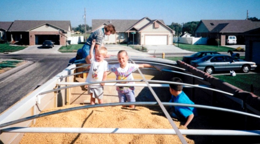 Playing in a truckload of soybeans with Aunt Sue, cousin Trent, and brother Ray, circa 1998