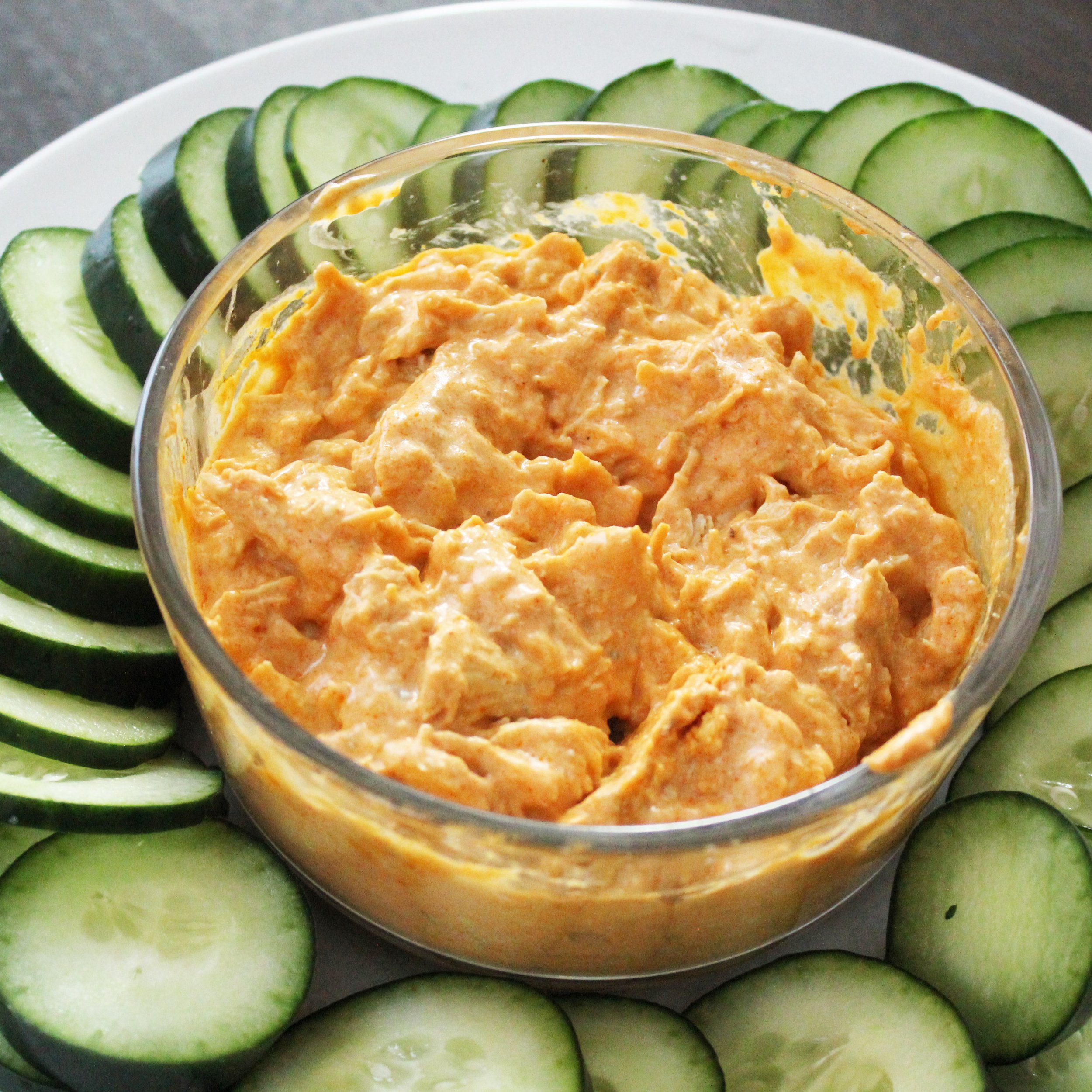 Buffalo Chicken Dip surrounded by sliced cucumbers