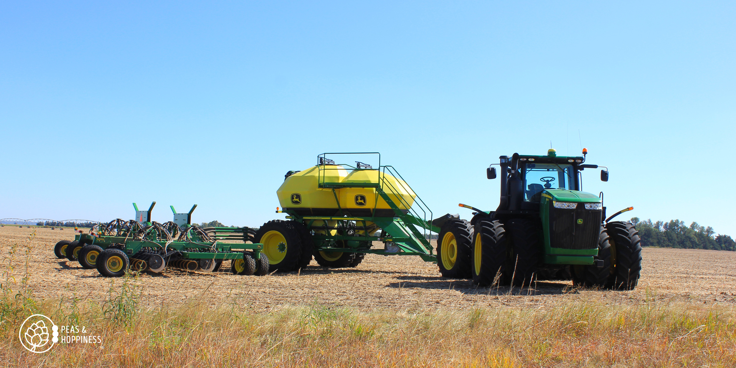 The air-seeder, used to drill wheat. The front hopper contains wheat seed; the rear hopper contain dry synthetic nitrogen