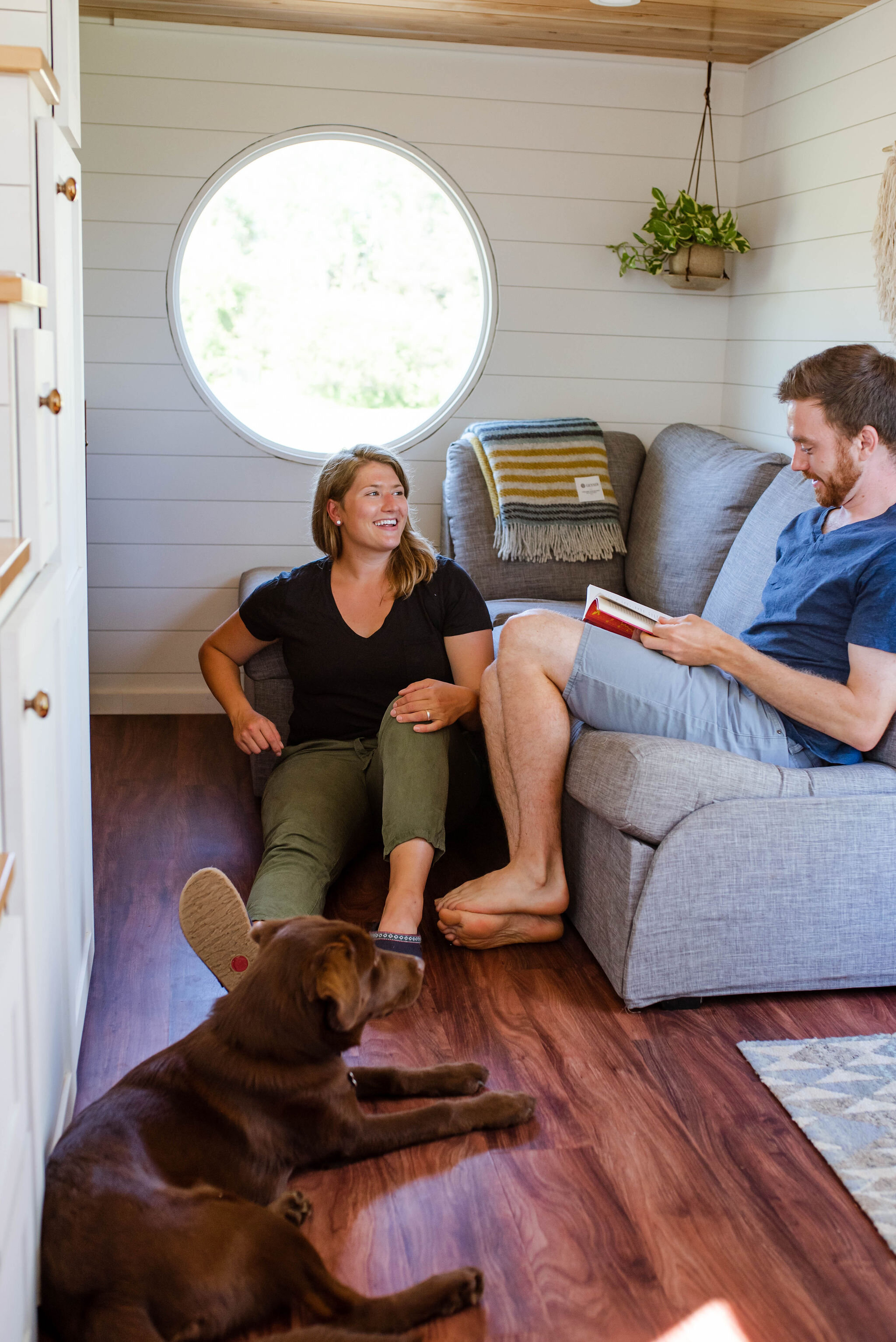 Sophie and Henry with their dog Cora in their Tiny Home outside of Duluth, MN. Photo cred: Sydney Carlino