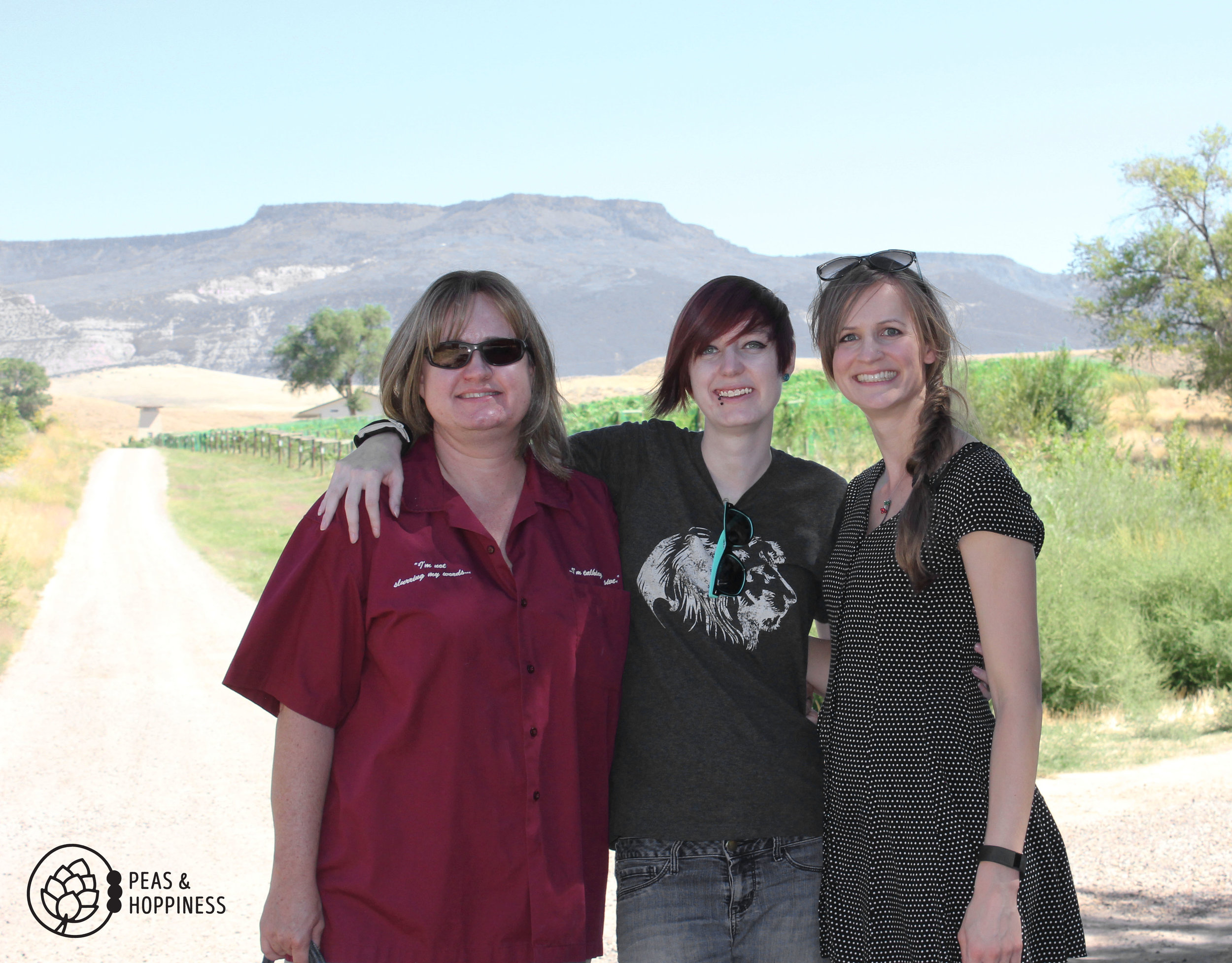 Lanette, Leanna, and me - with the grapes behind us and the mesa in the background.