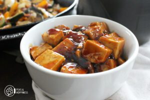 Bowl of tofu cubes covered in teriyaki sauce