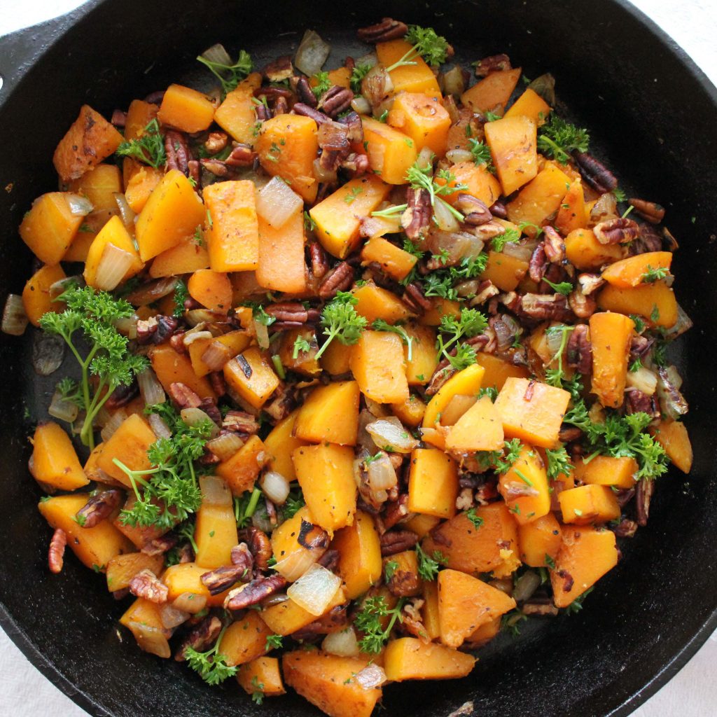 Cast Iron Skillet filled with Butternut Squash, onion, pecans, and parsley - Fall and Winter Seasonal Dish