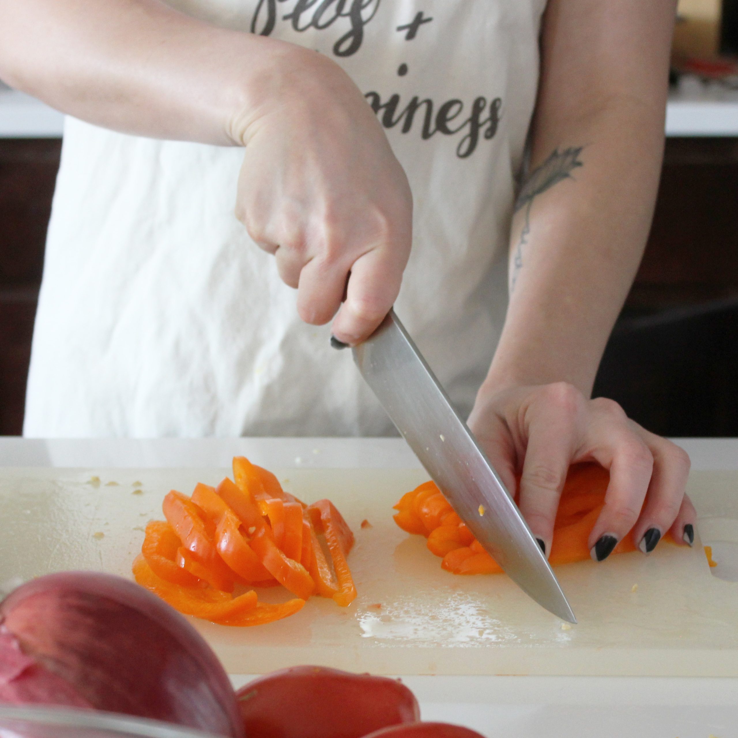 Dicing an orange bell pepper using a chef's knife