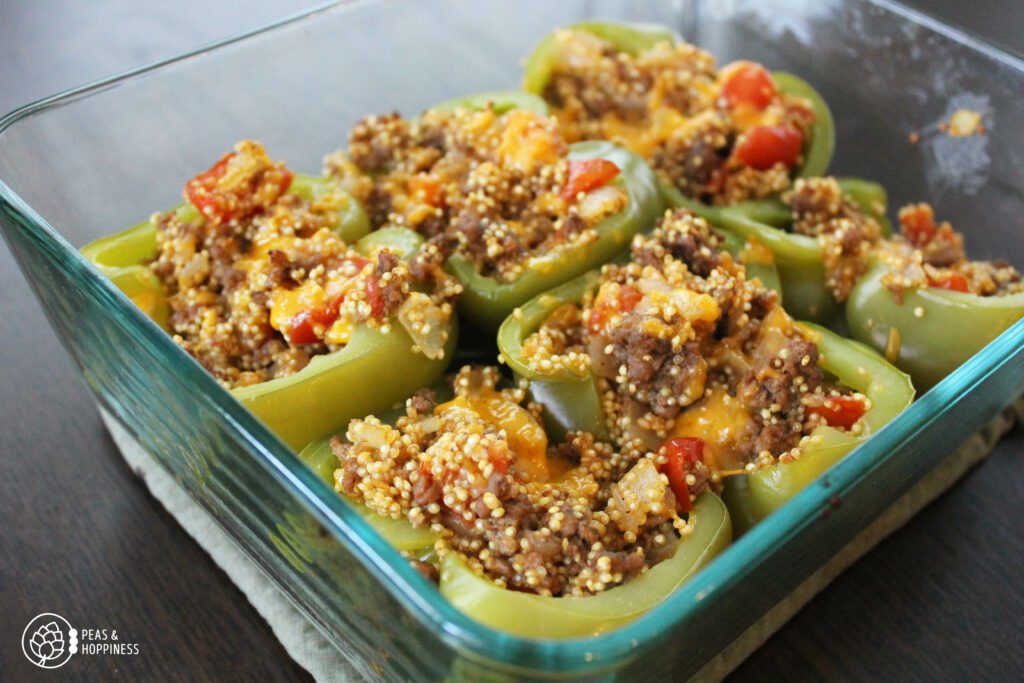 Stuffed pepper halves: recipe for Cheesy Quinoa Stuffed Peppers featured on the Peas and Hoppy Meal Guides customizable meal planning service