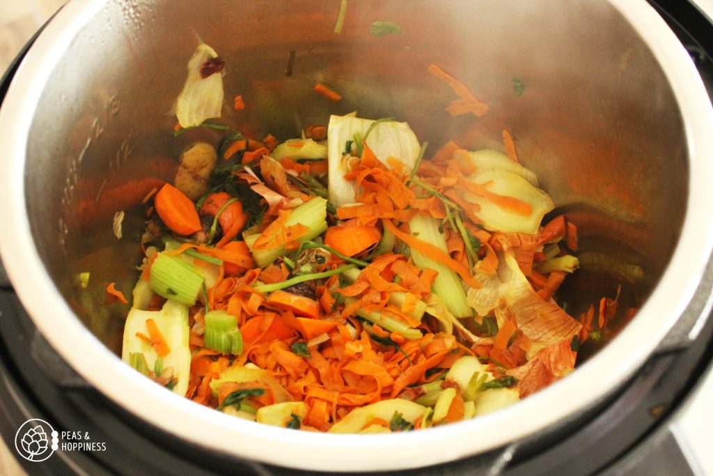 Vegetable scraps sauteing in a large pot