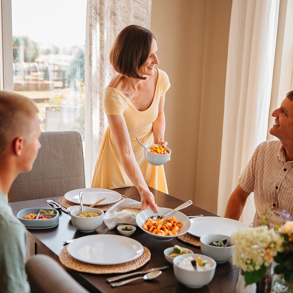 Dietitian Ann Kent and her family eating dinner together. Family mealtime is a great way to fix picky eating!