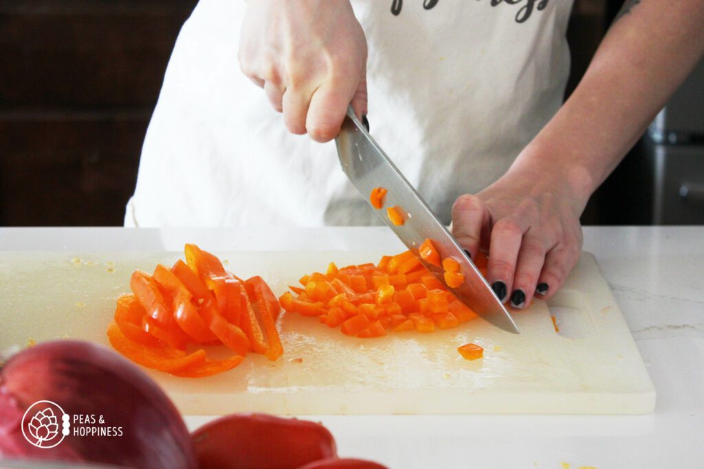 Dicing an orange bell pepper using a chef's knife
