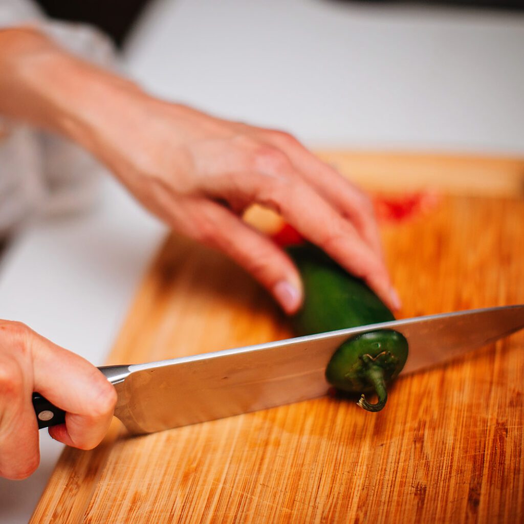 Slicing a jalapeno pepper - choose seasonal produce for best nutrition, taste, and price